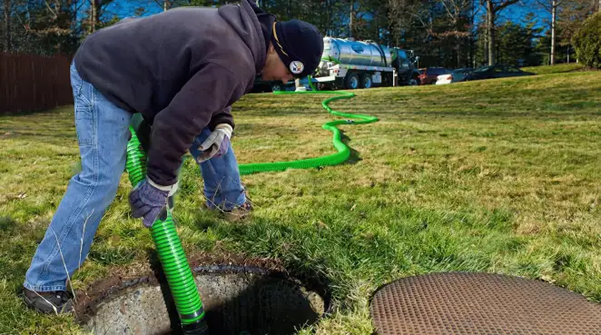 Service technician performing residential septic pumping and drainage maintenance in Anaheim, CA